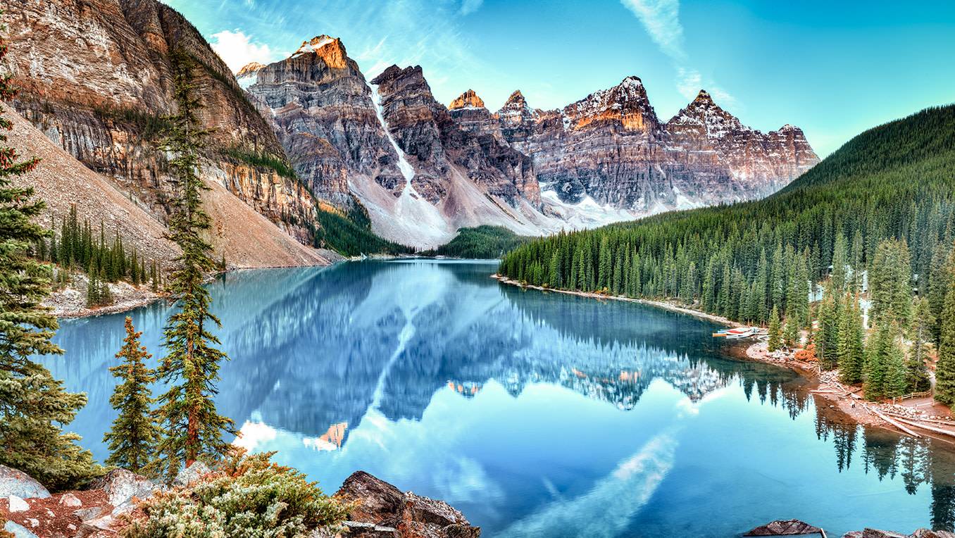 Brilliant panorama picture of mountains reflecting in Moraine Lake in Banff National Park, Alberta, Canada