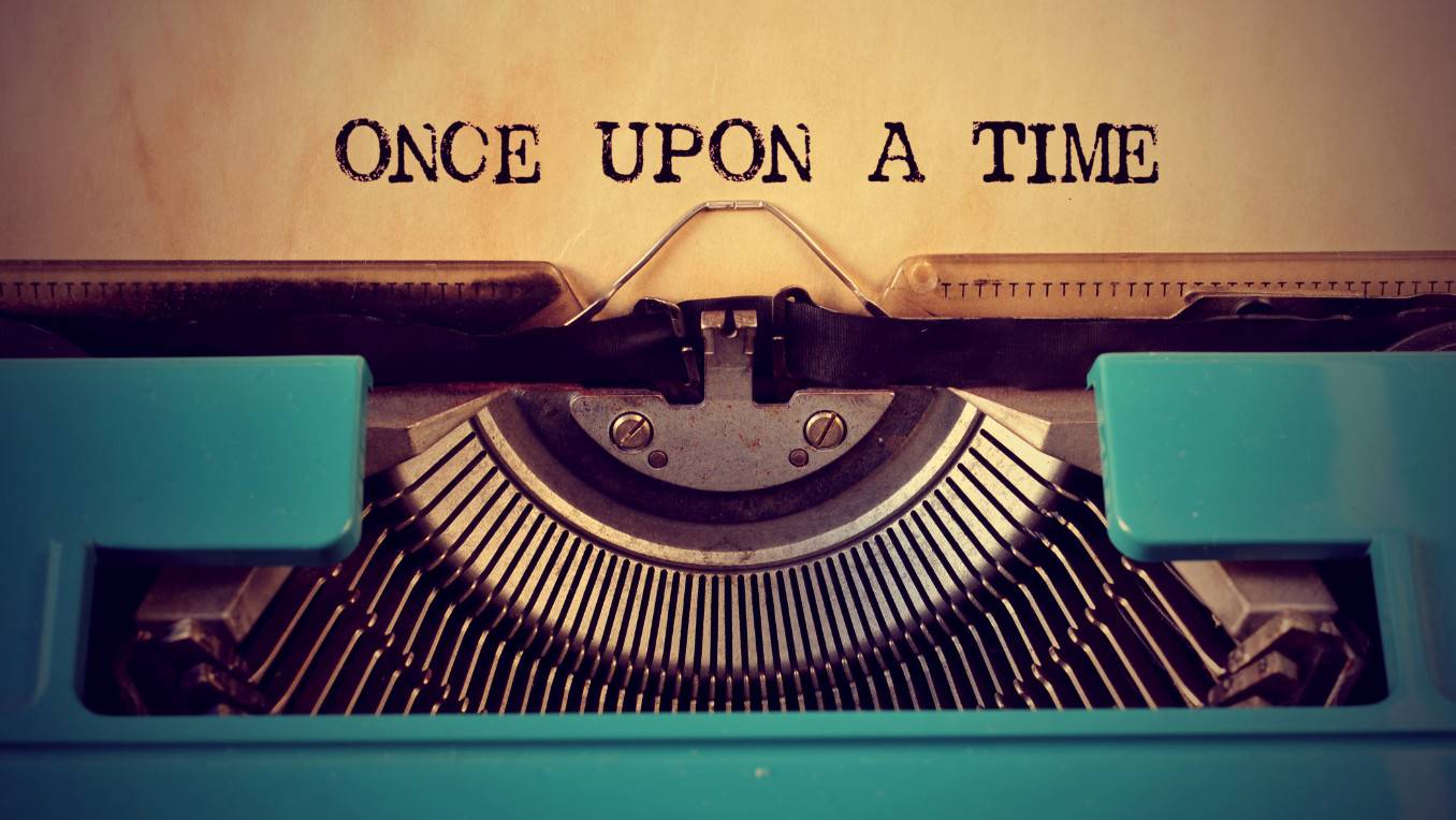 A piece of paper has been inserted into a typewriter and the text reads: Once Upon a Time