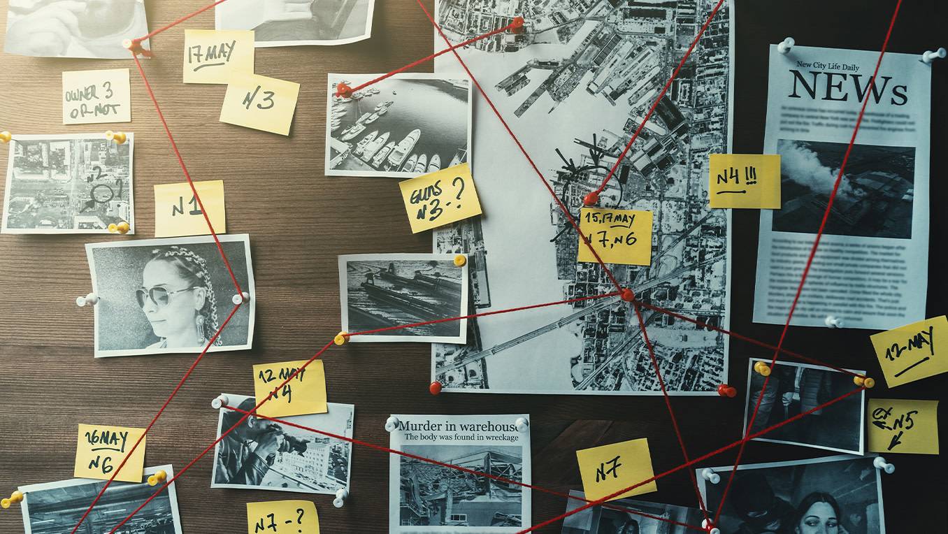 A board with pictures and news clips show a detective trying to solve a crime by connecting pictures with red strings and yellow paper notes