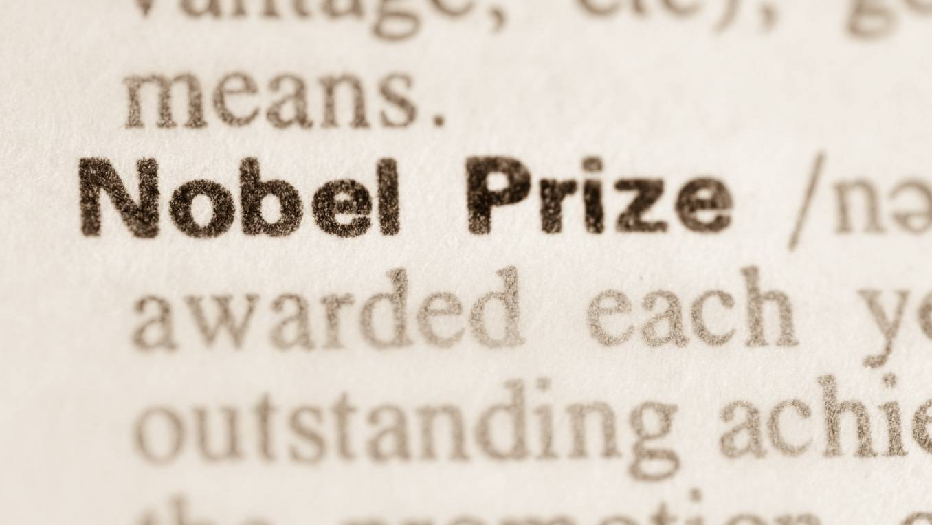 A photo of a closeup on a dictionary with the focus on the entry “Nobel Prize”